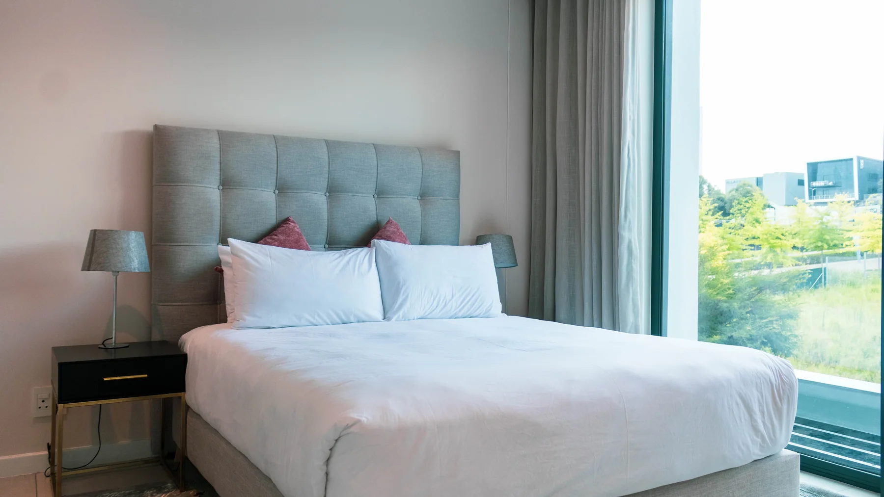Furnished bedroom with large window in Unit 113