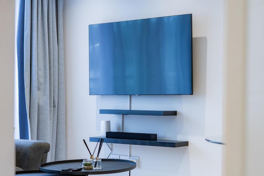 Television and media wall in the living room at Unit 125